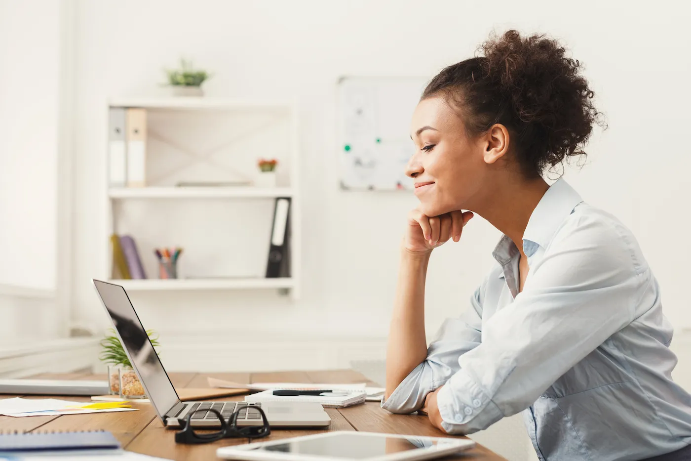 Happy smiling business woman working on laptop at office.