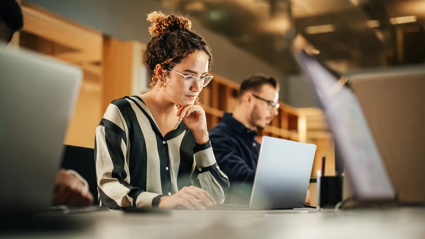 Portrait of Woman Working on Computer in a Modern Bright Office.