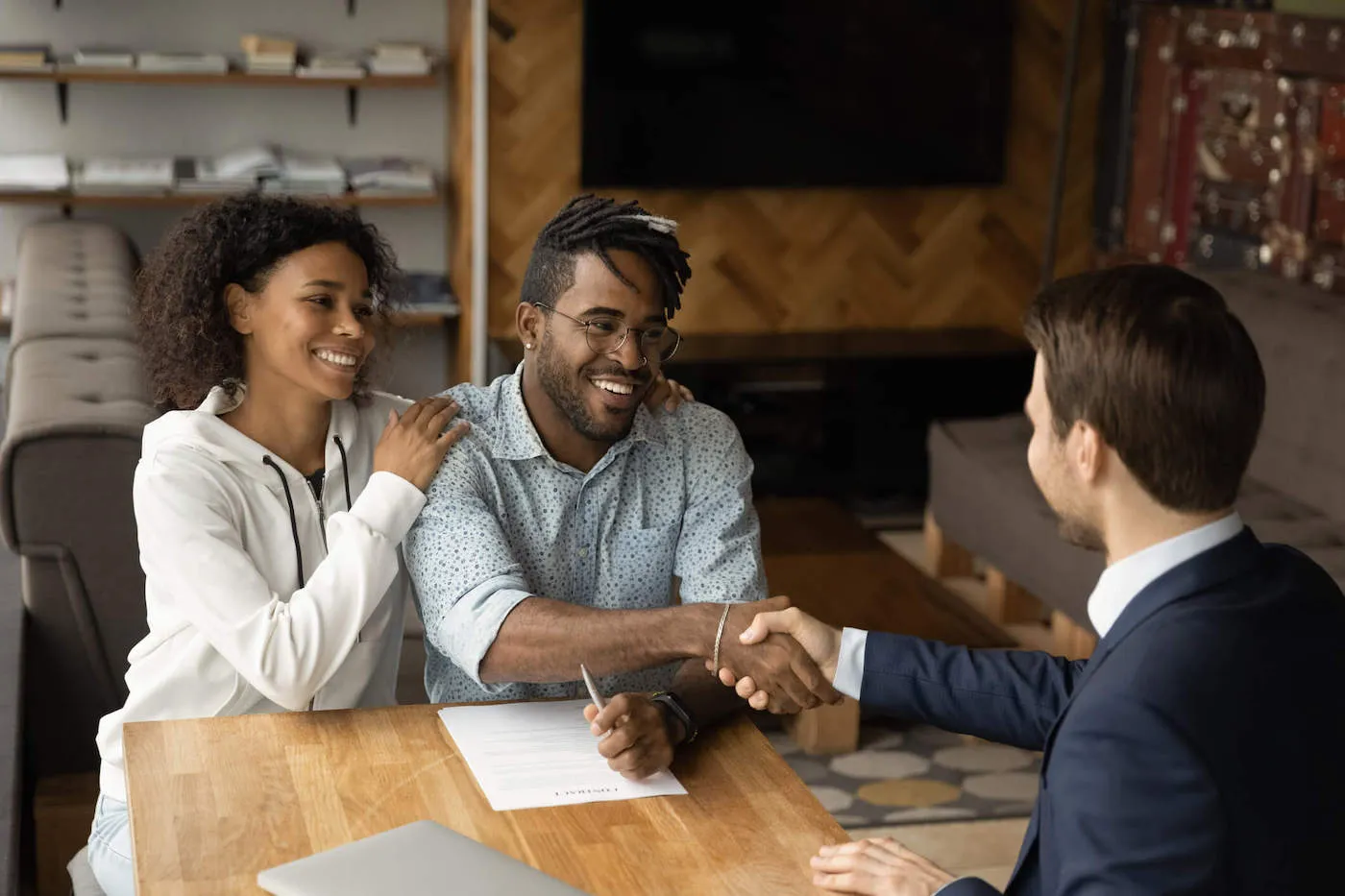 man and woman couple getting real estate planning advice seated at a table