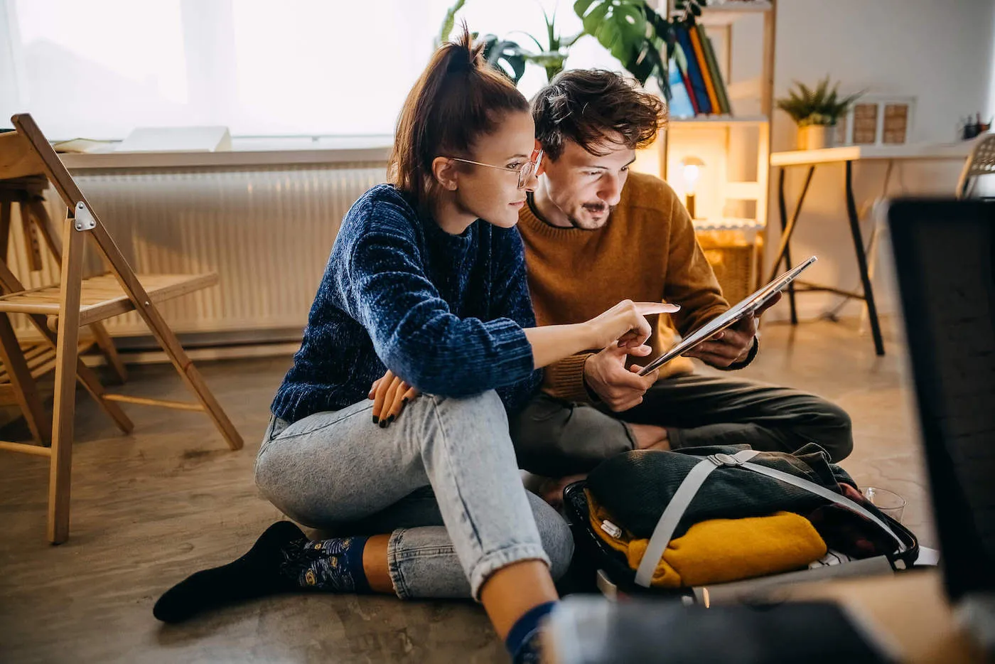 Couple planning vacation trip and searching information on tablet.