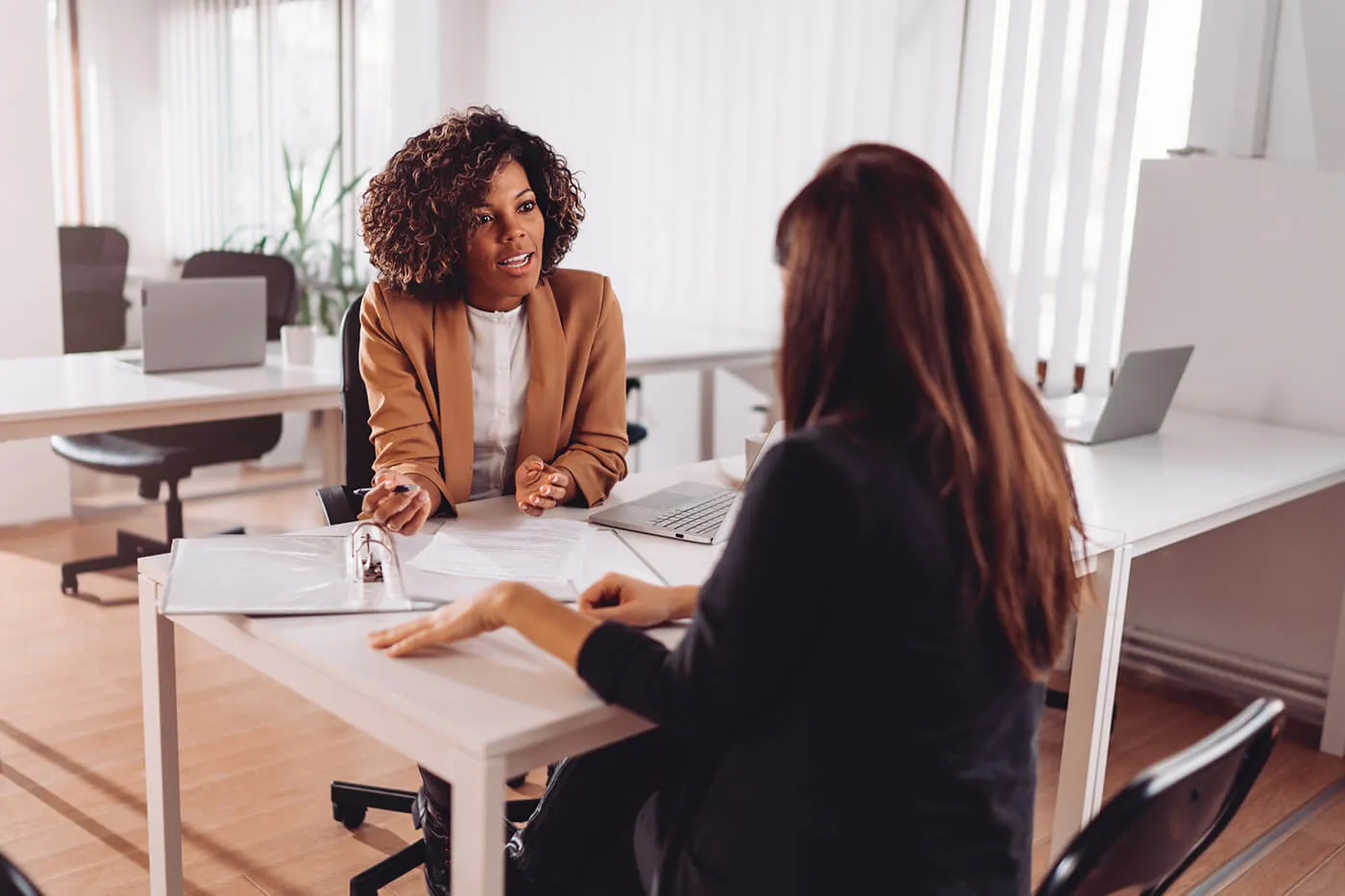 Financial consultant manager talking with a female client at the bank