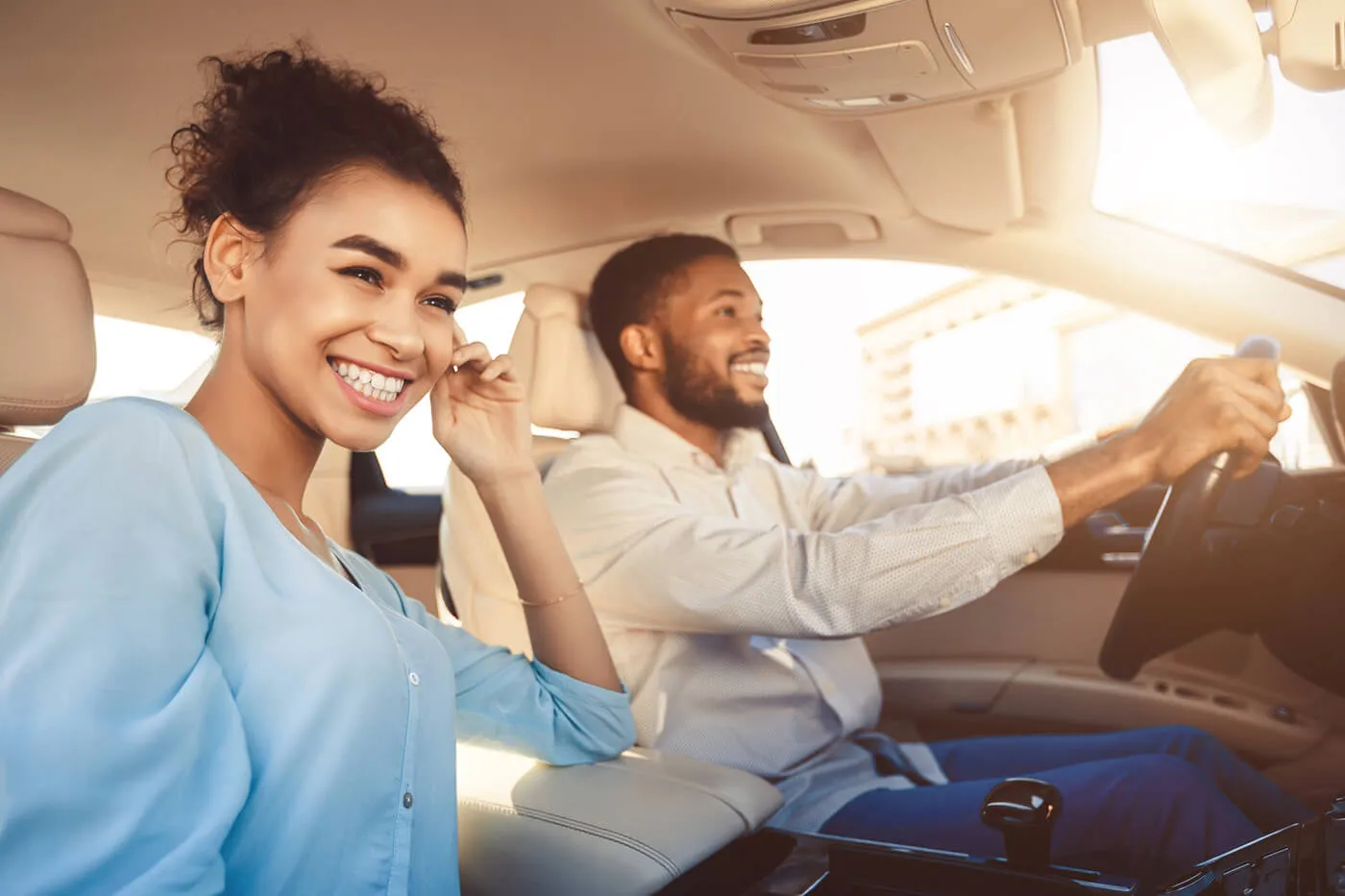 Young african american couple driving in car, travelling together