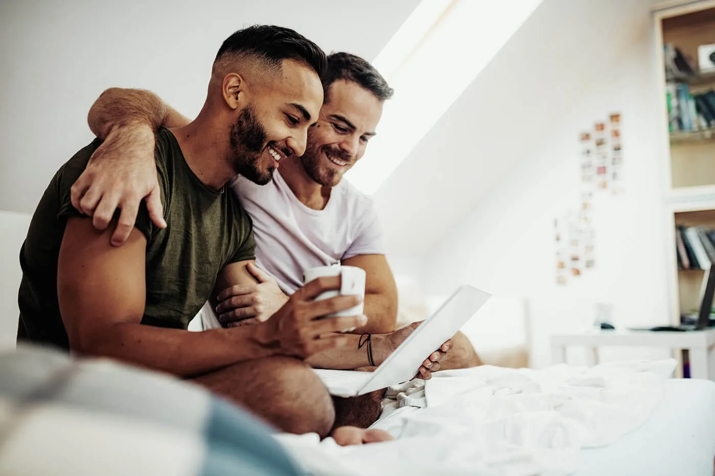 Gay couple at home in penthouse, looking over their personal finances together.