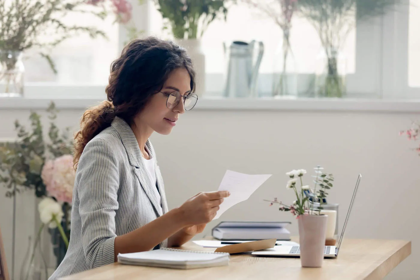 woman seated at table researching how ssi affects credit