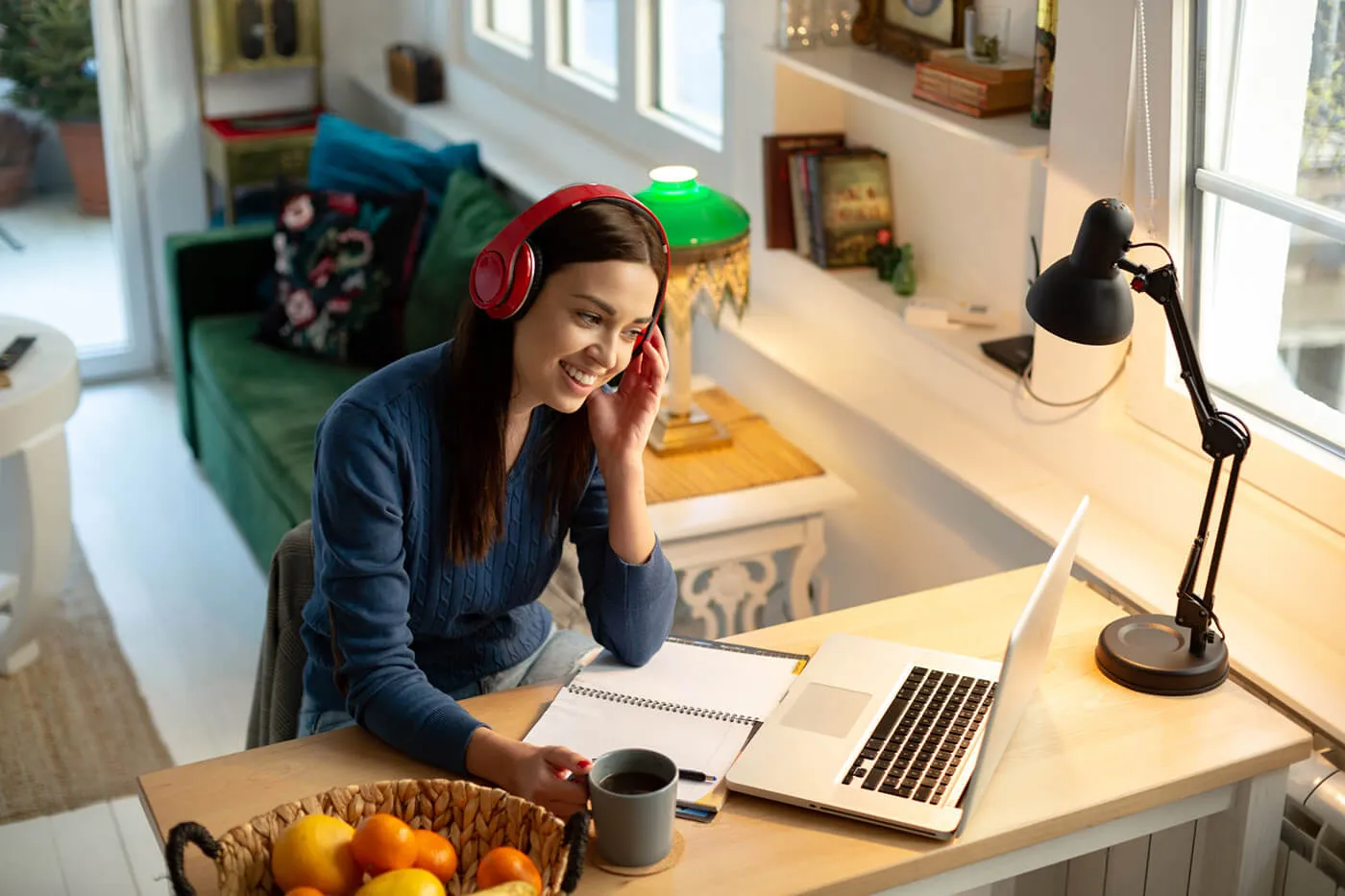 A young woman in an online class from home using her laptop.