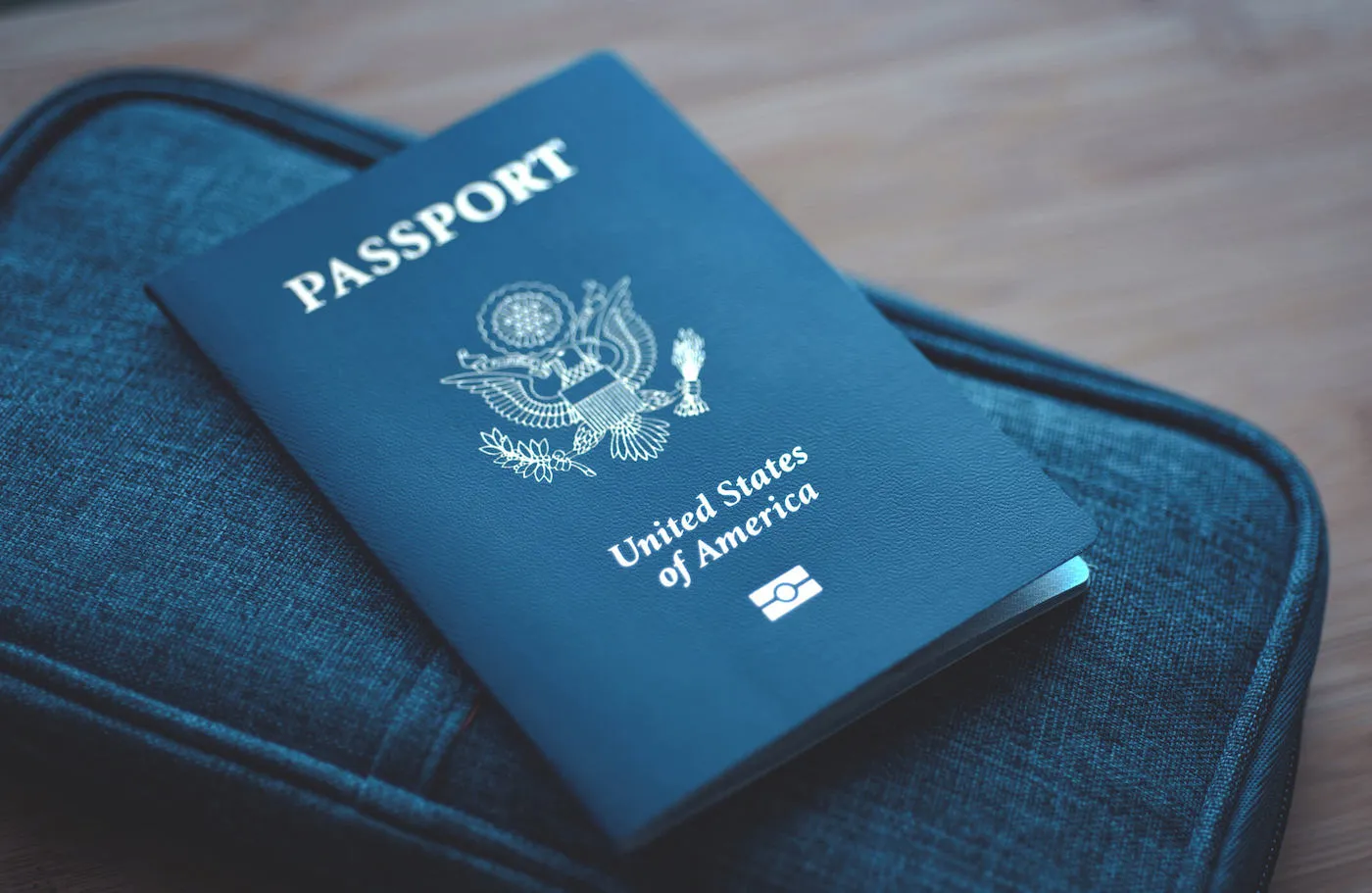 passport on top of a bag on a table