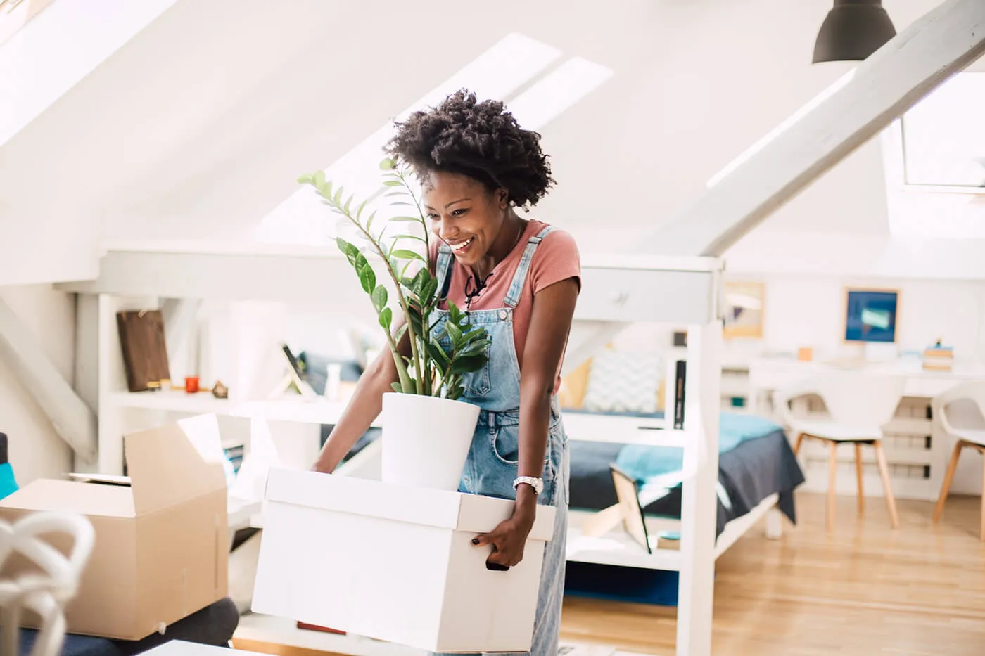 Happy African-American woman moving into a new home