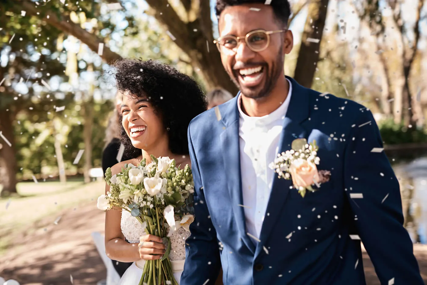 Shot of a happy newlywed young couple getting showered with confetti outdoors on their wedding day.