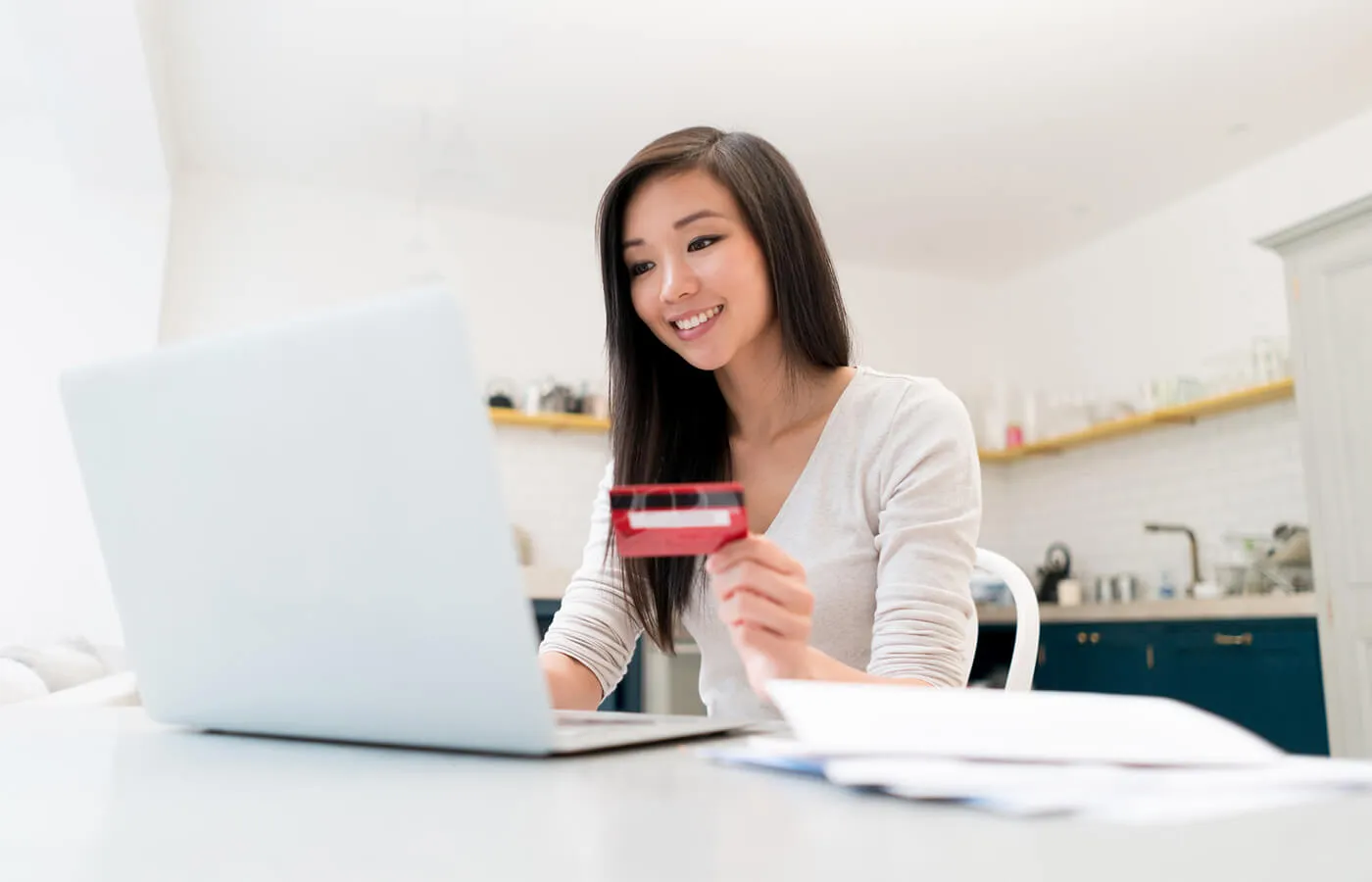 Woman using laptop with credit card