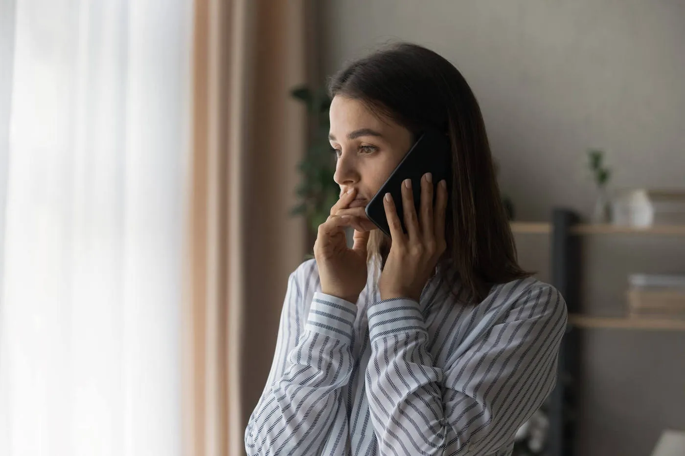 Sad compassionate young lady support friend in phone talk.