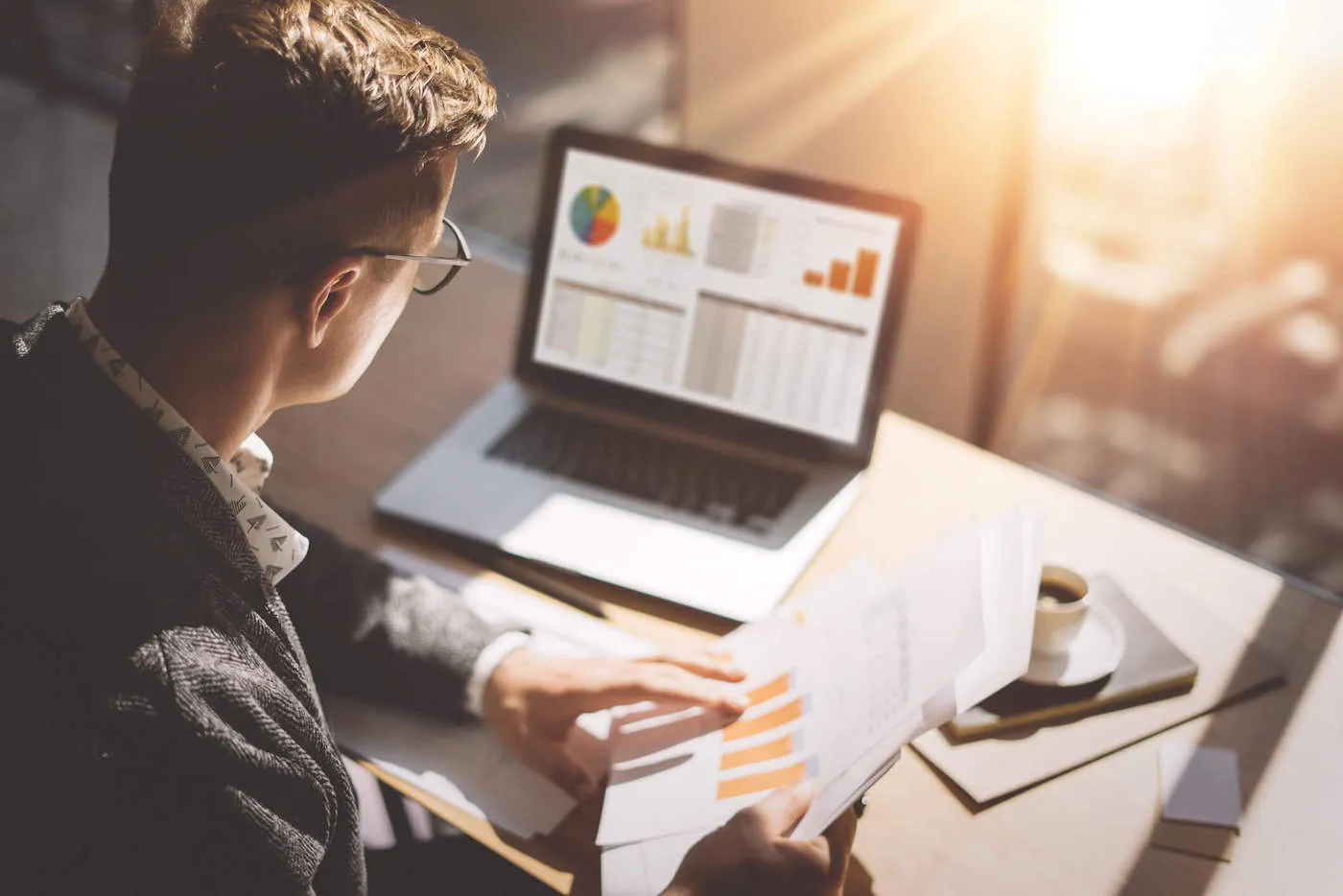 man looking over investments seated at a desk