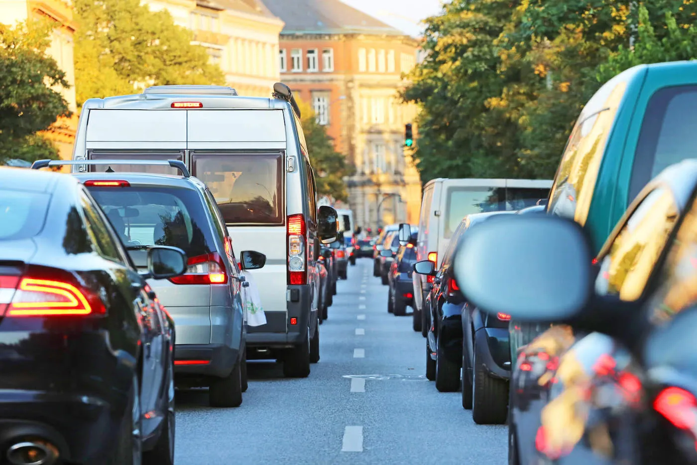 cars waiting in traffic in city street