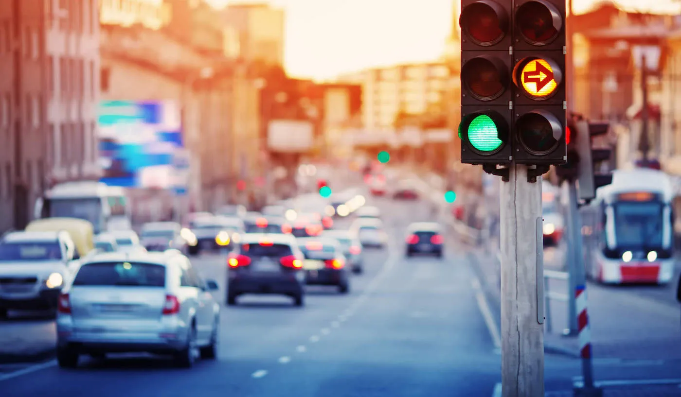 traffic lights in city street with cars passing by