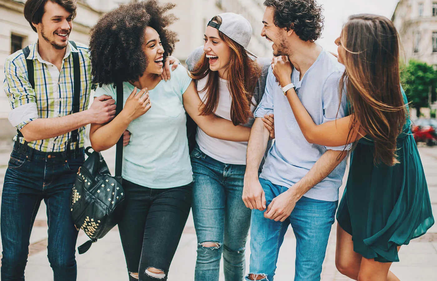 A group of teens walking and hanging out together.