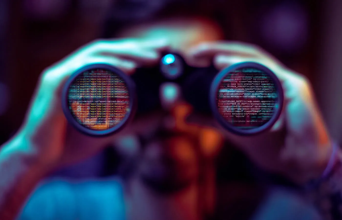 A man looking through a pair of binoculars.