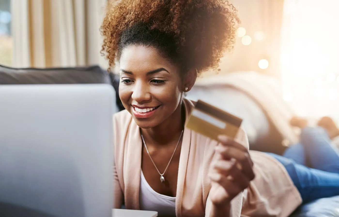 Woman on her laptop shopping with credit card