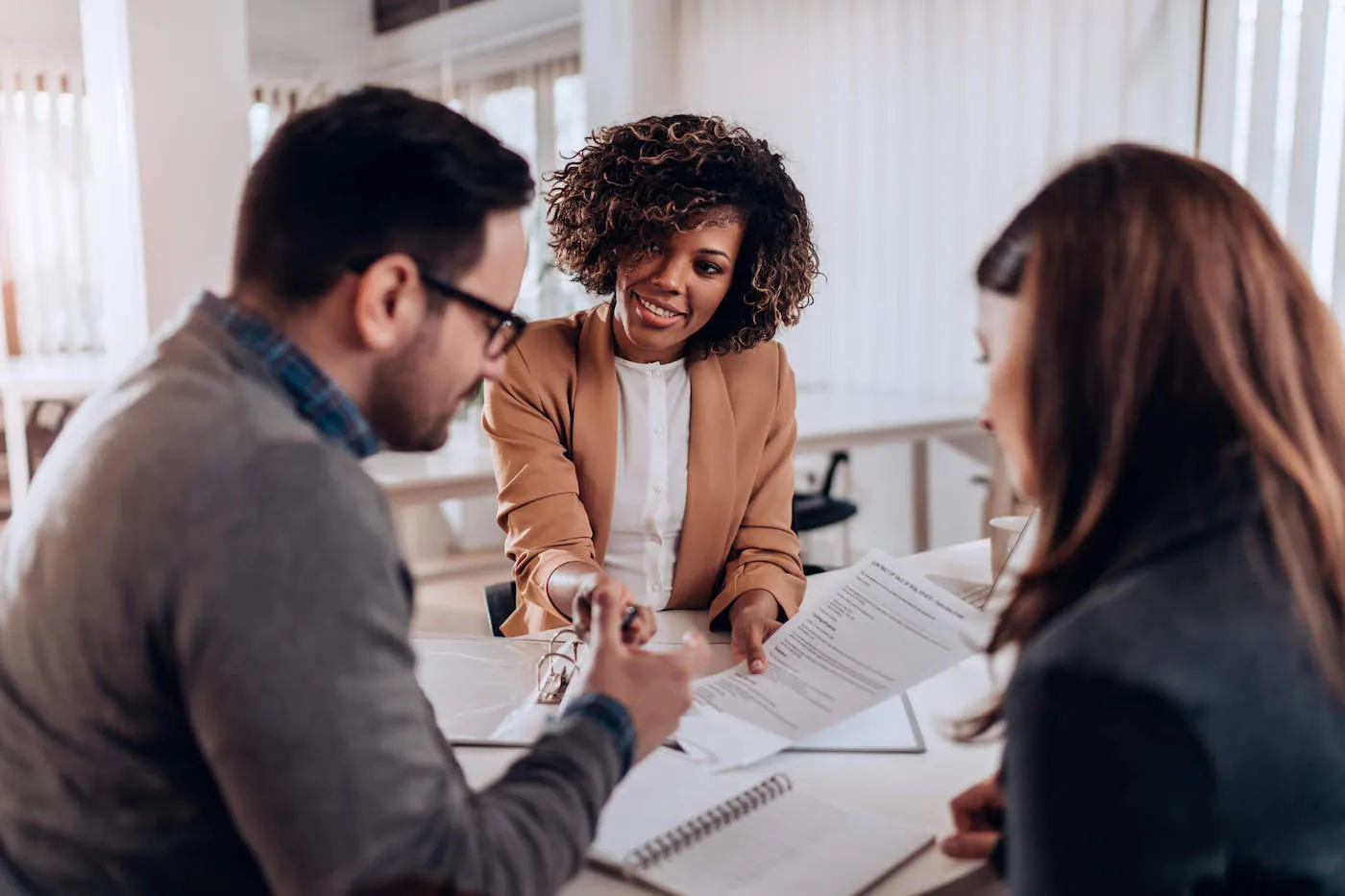 woman explaining to a couple how tax exemption works