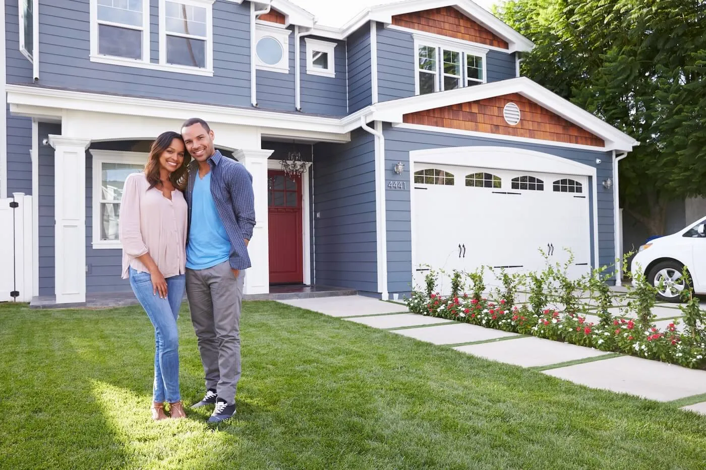 Couple in front of their new house