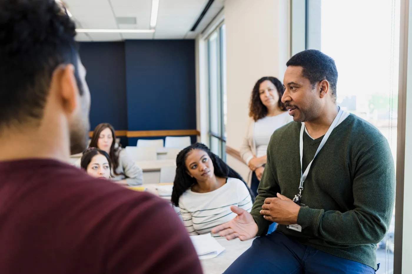 Adult college student explains concept to help classmates