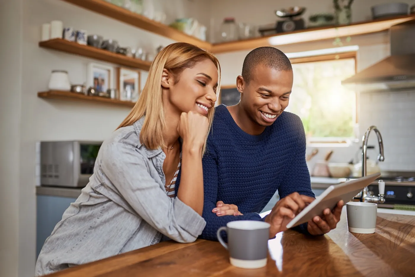 A young couple checking their CD account on the tablet