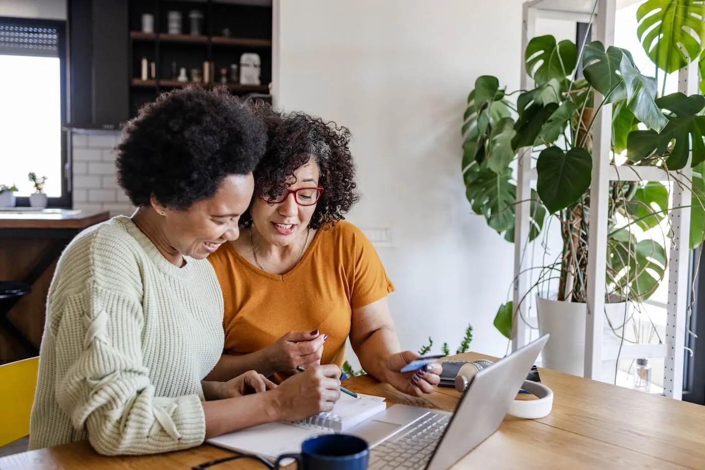 Two mature women review their credit reports