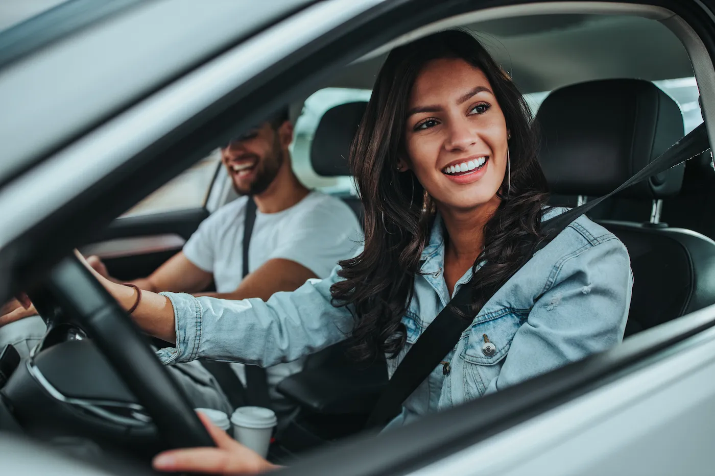 Happy couple enjoying while traveling by car and going on trip