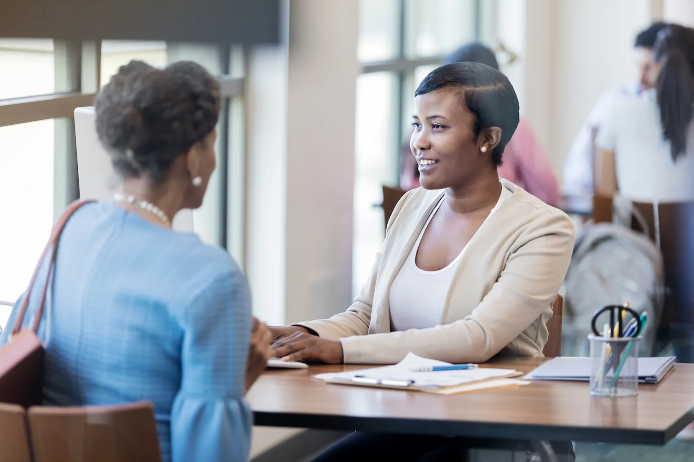 Banker helping a customer at her desk