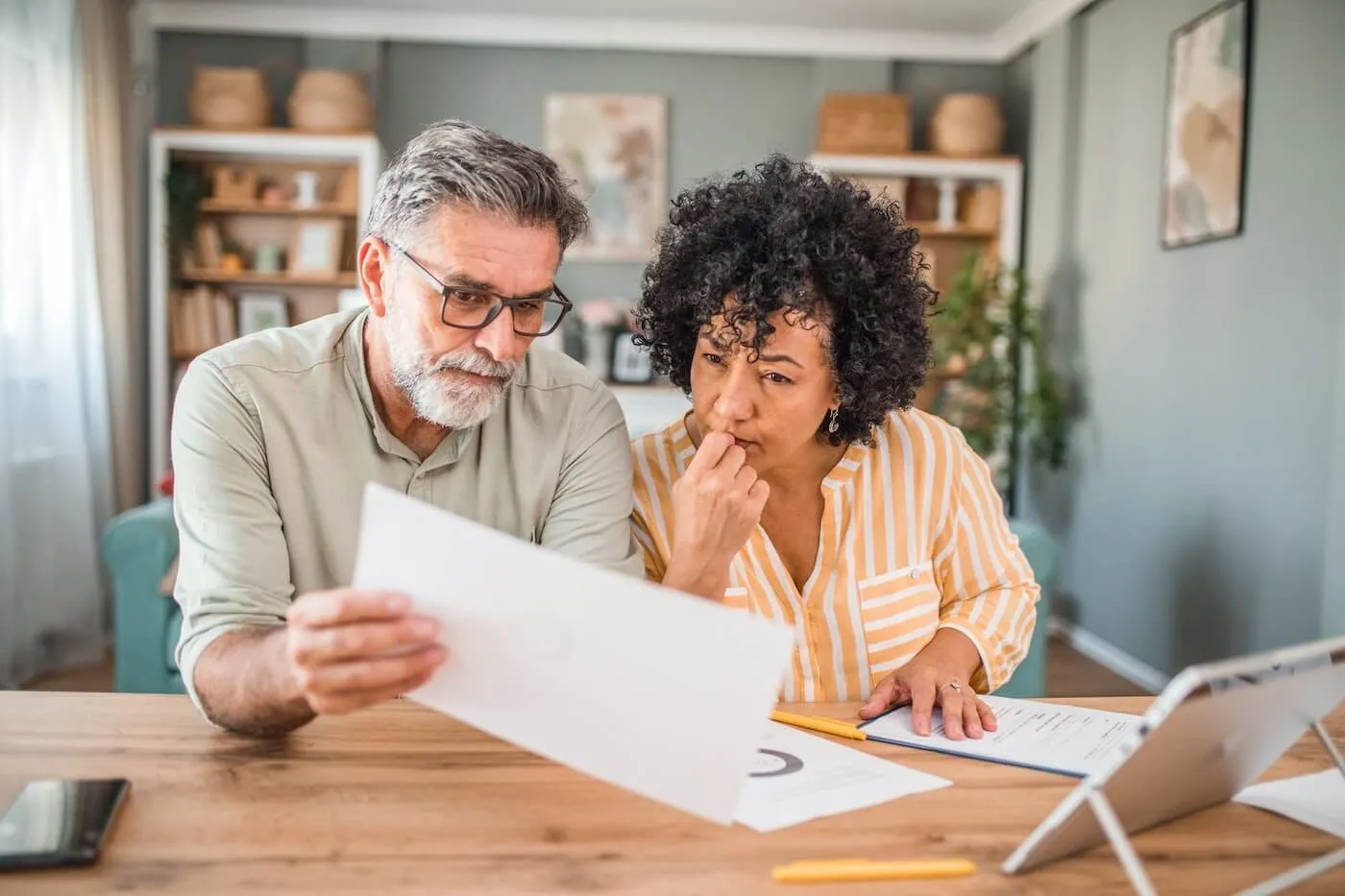 Mature couple planning their finances at home