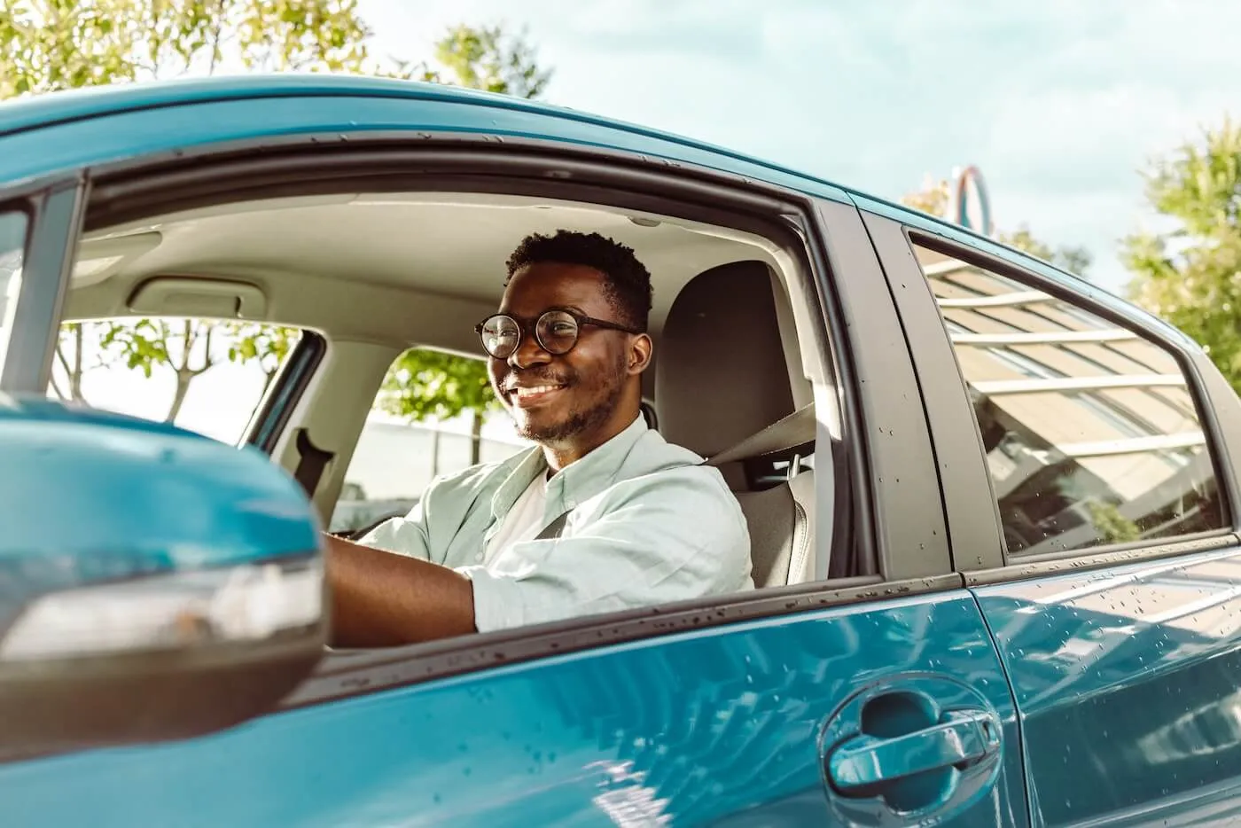 Smiling man driving a car