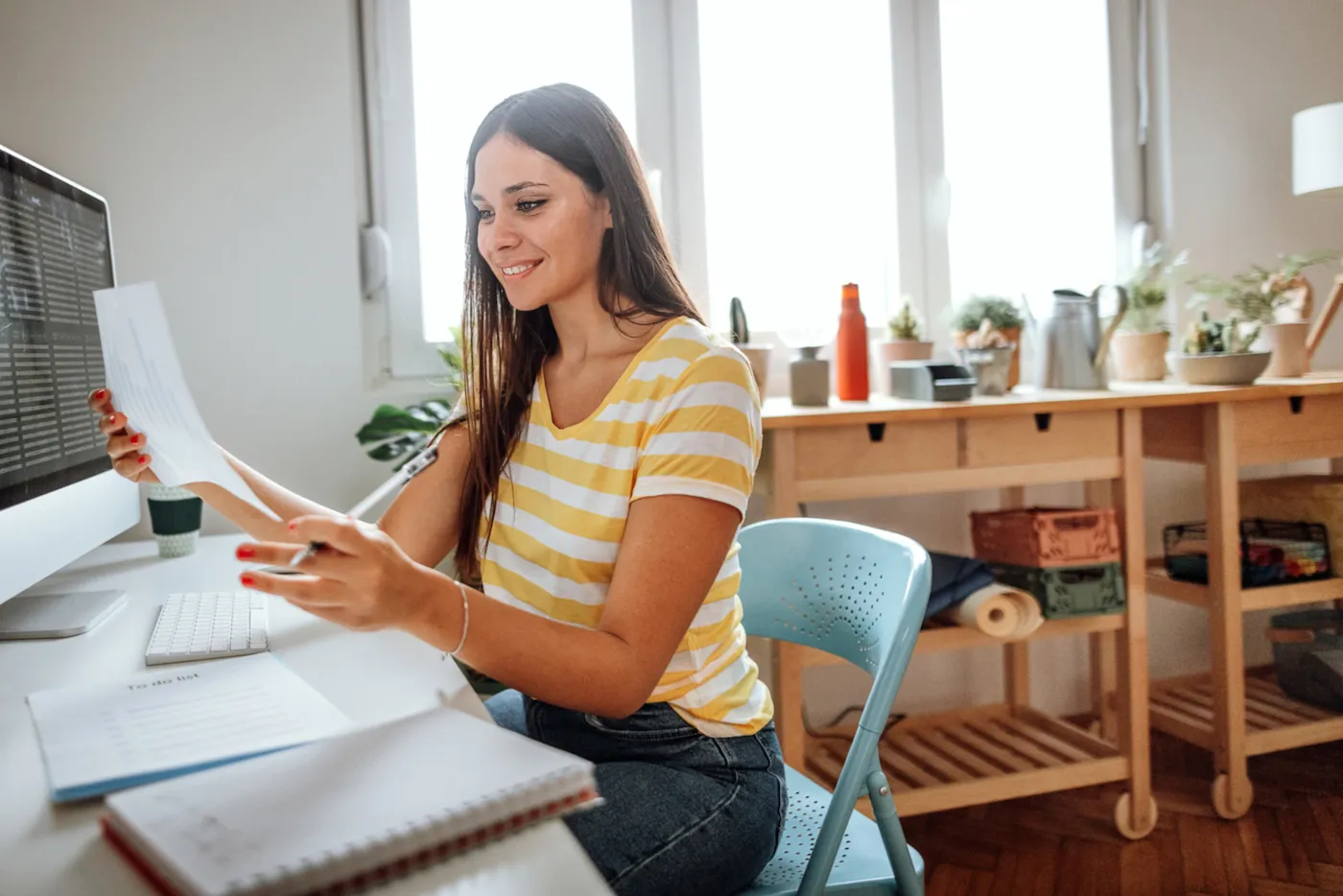 Shot of a young woman working from home on her emergency savings.