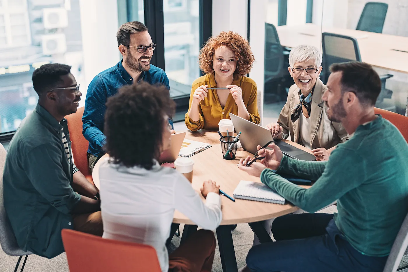 Group of business people having a meeting around a round table.