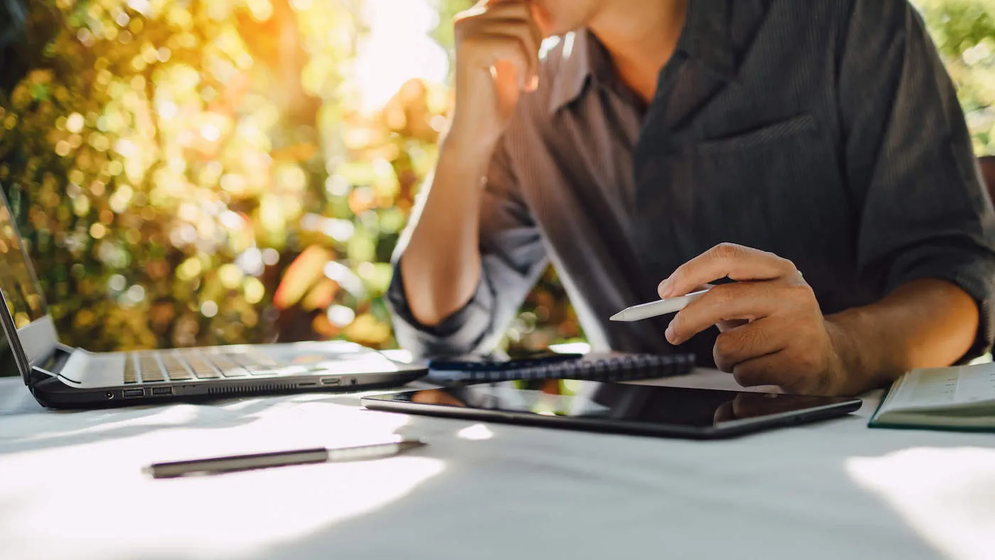 Businessman analyzing company annual financial report balance sheet statement working with documents graphs.