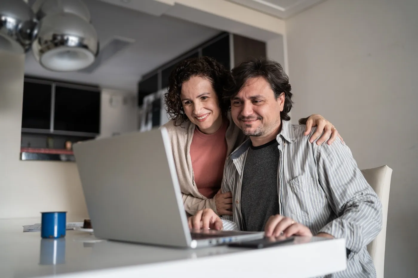 Mature couple using laptop together at home.