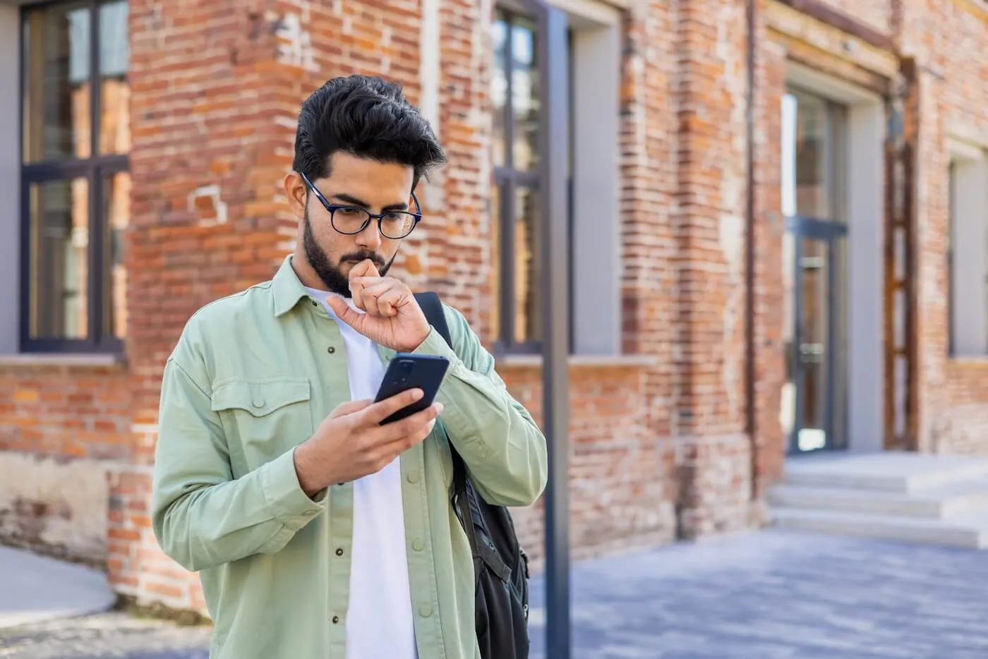 Concerned young man checking his smartphone