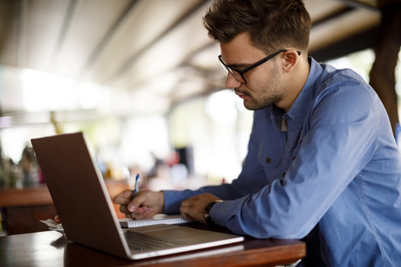 Young man working at a cafe