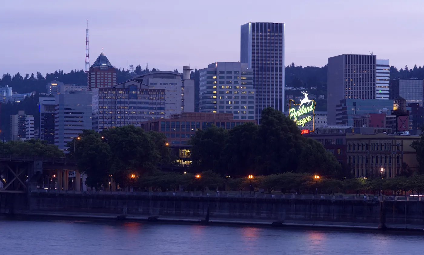 Portland Oregon across the Willamette River at Dusk, with a view of the white stag sign.