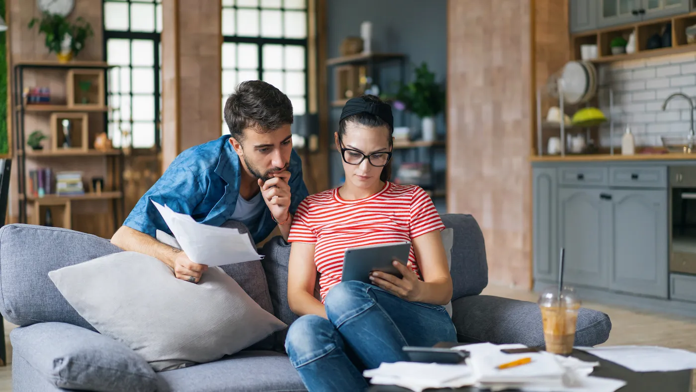 Couple weighing pros and cons of a high yield savings account