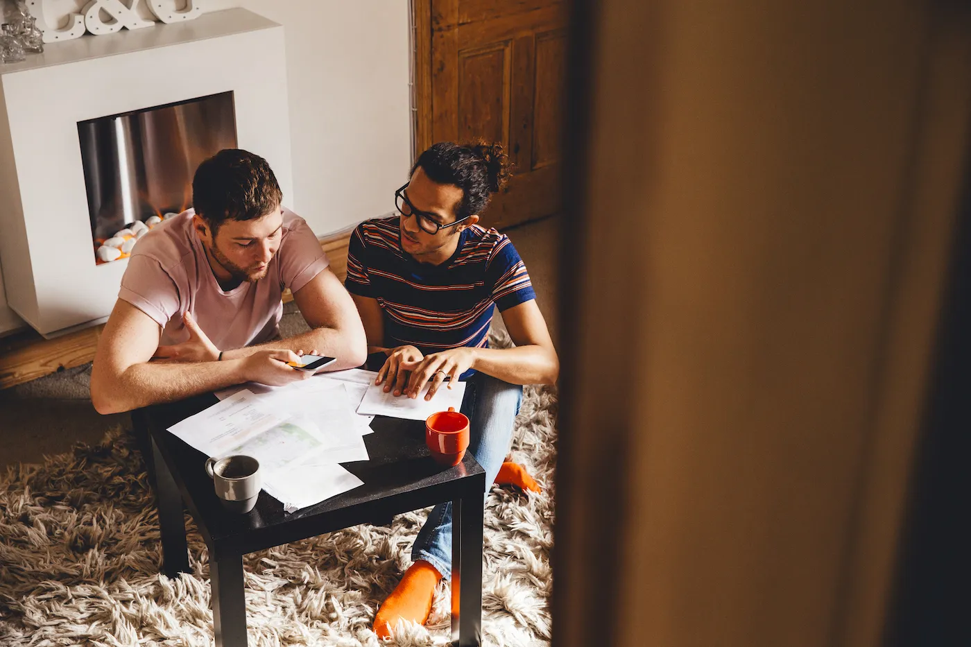 Couple looking through debt documents together in their home.