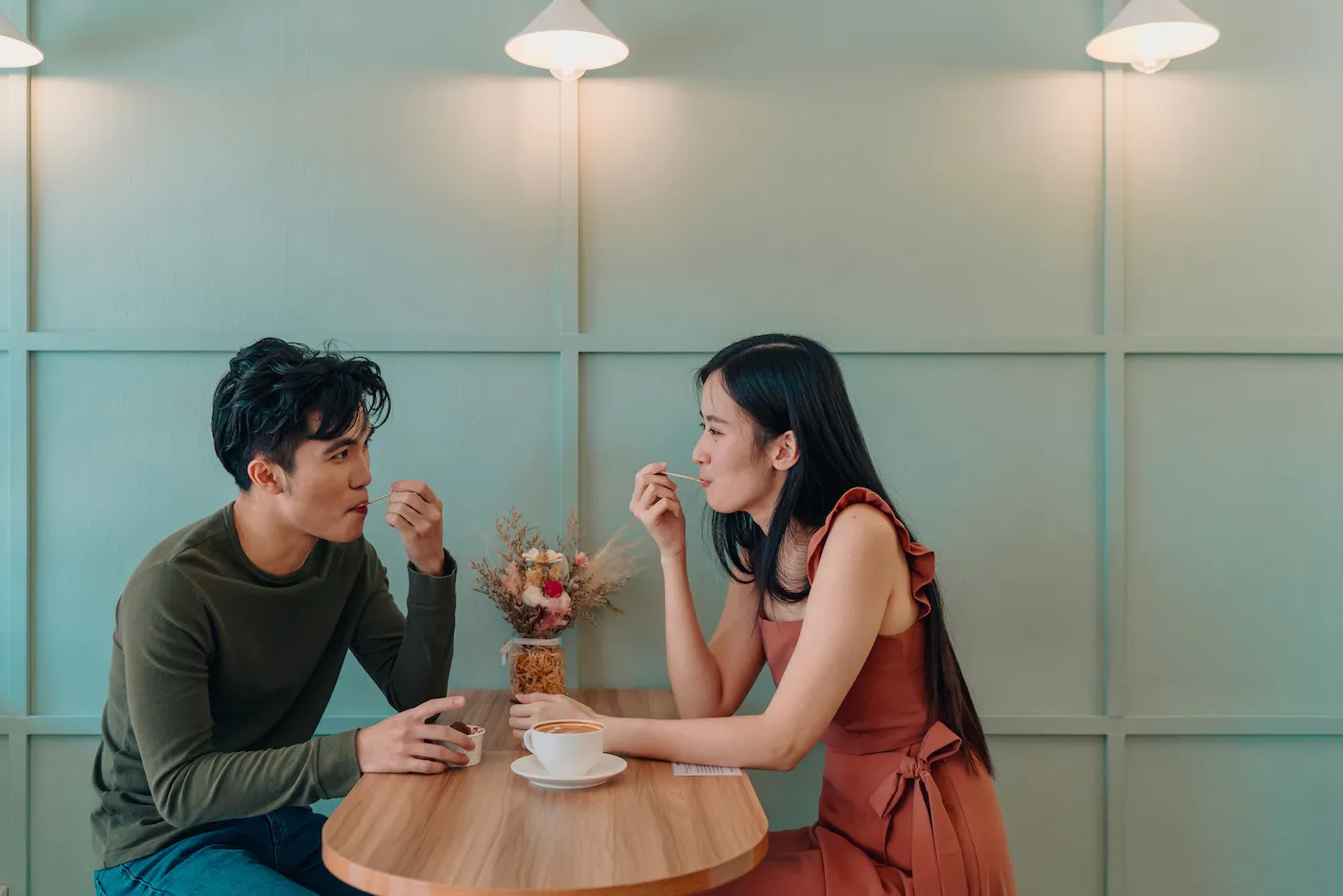 Young couple locking eyes in a cafe