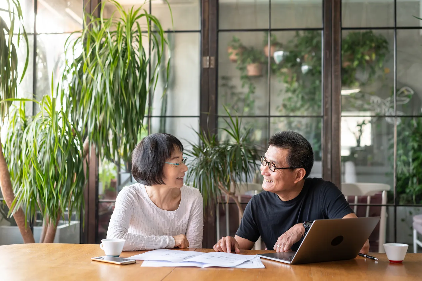 Asian couple planning their retirement at home.