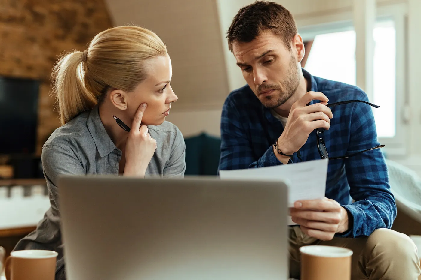 Young couple analyzing their mortgage at home.