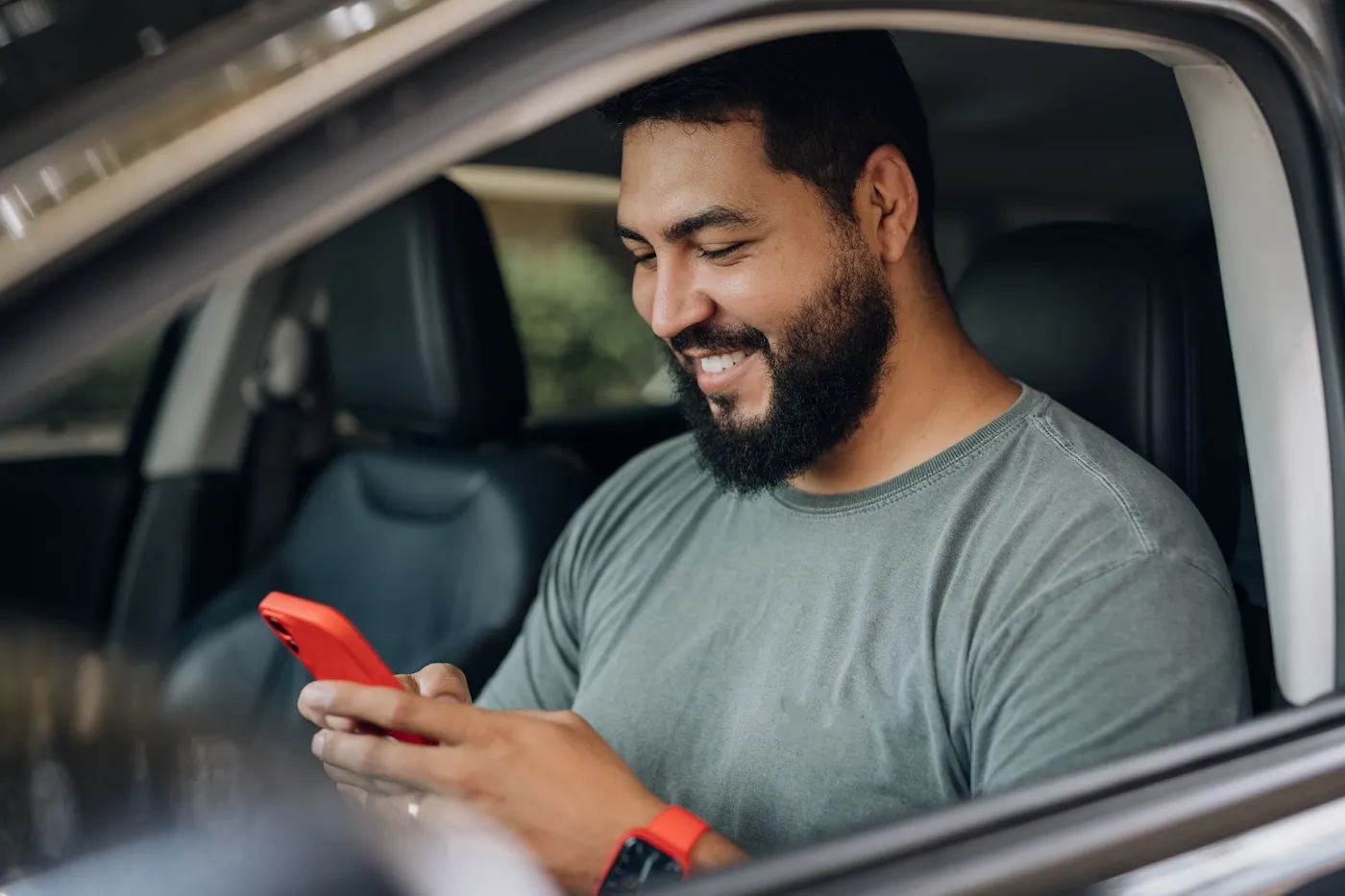 A parked driver reading on smartphone