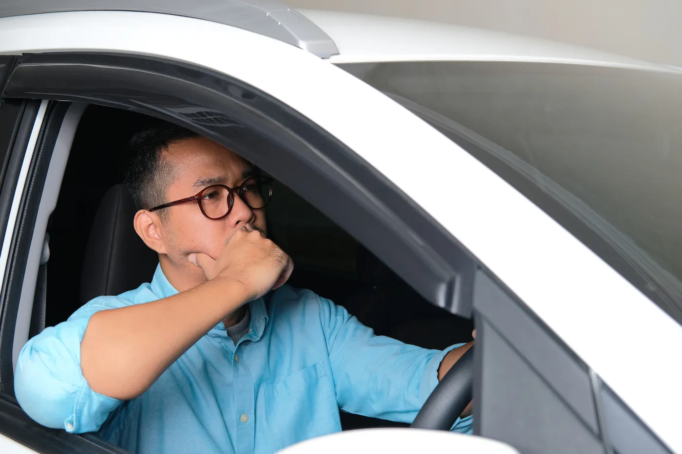 Adult man driving his car with serious face expression