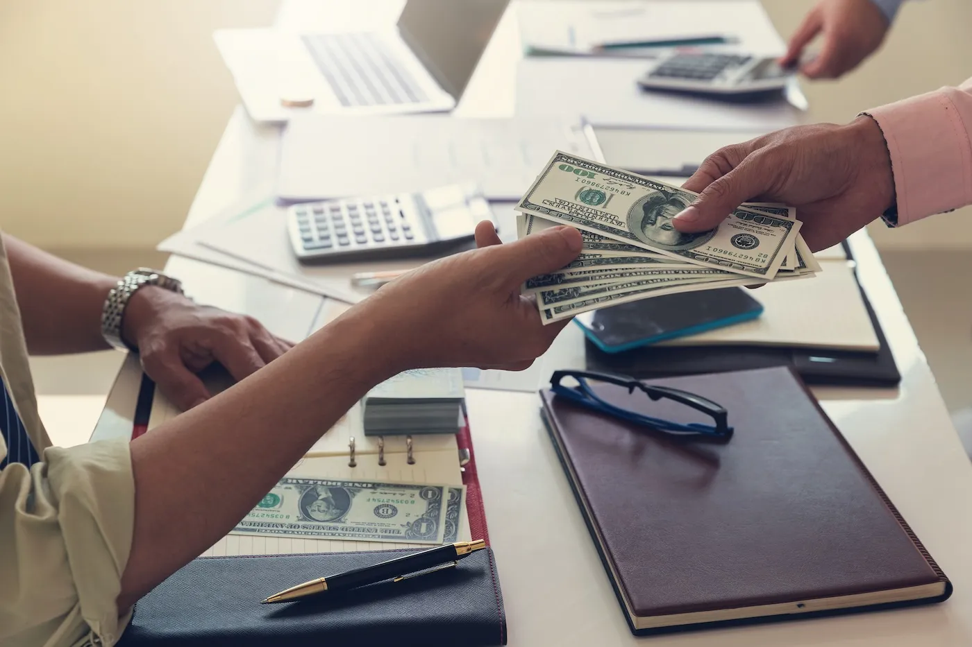 A person receiving a cash advance at the bank.