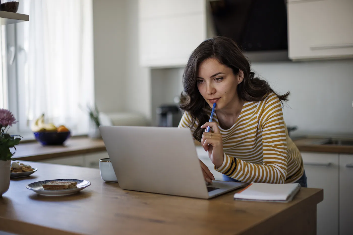 Young woman using a laptop to research loans.