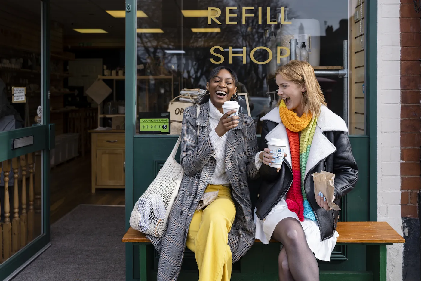 Two friends sitting outside a coffee shop