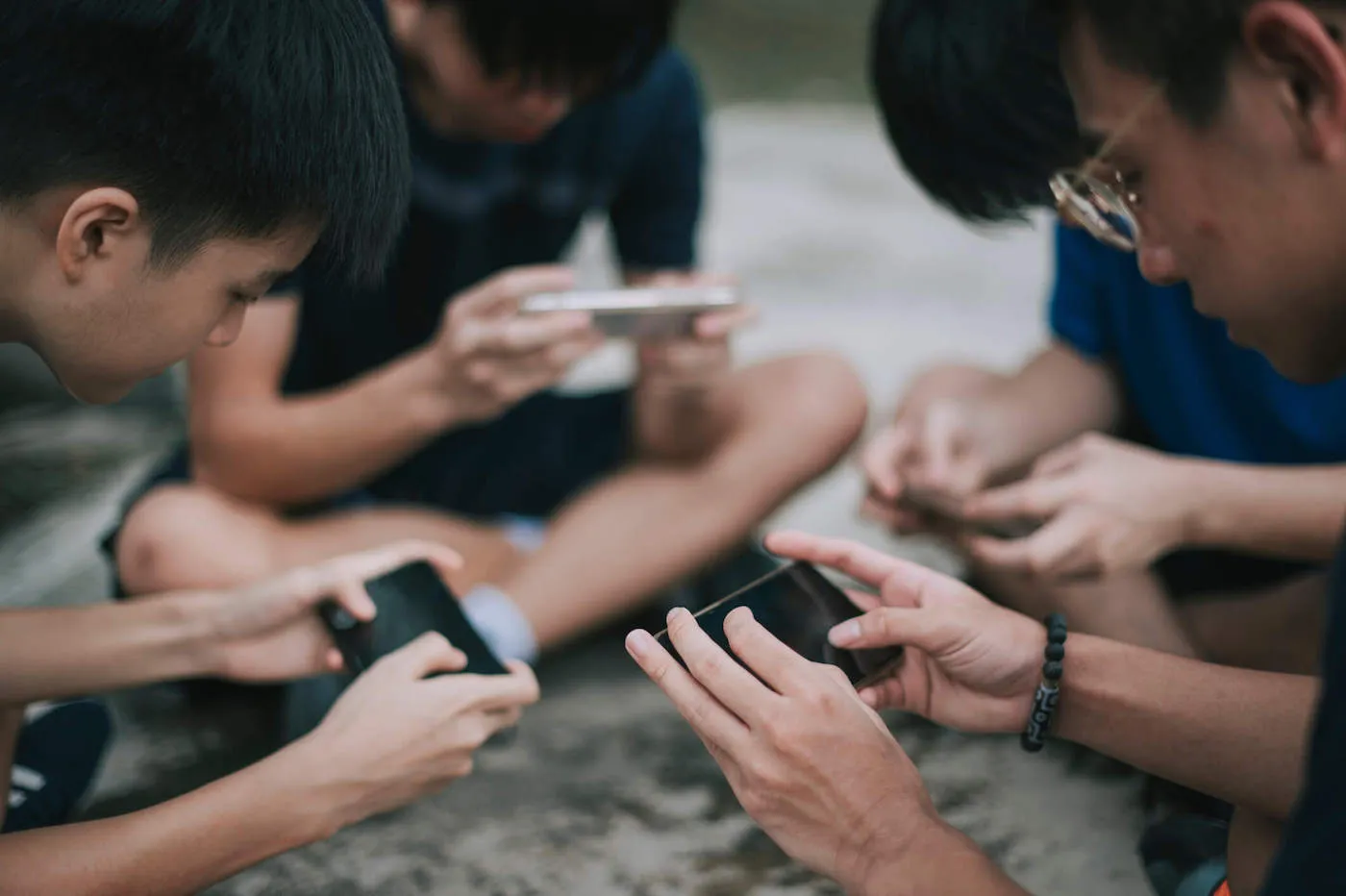 Group of young boys playing online personal finance games.