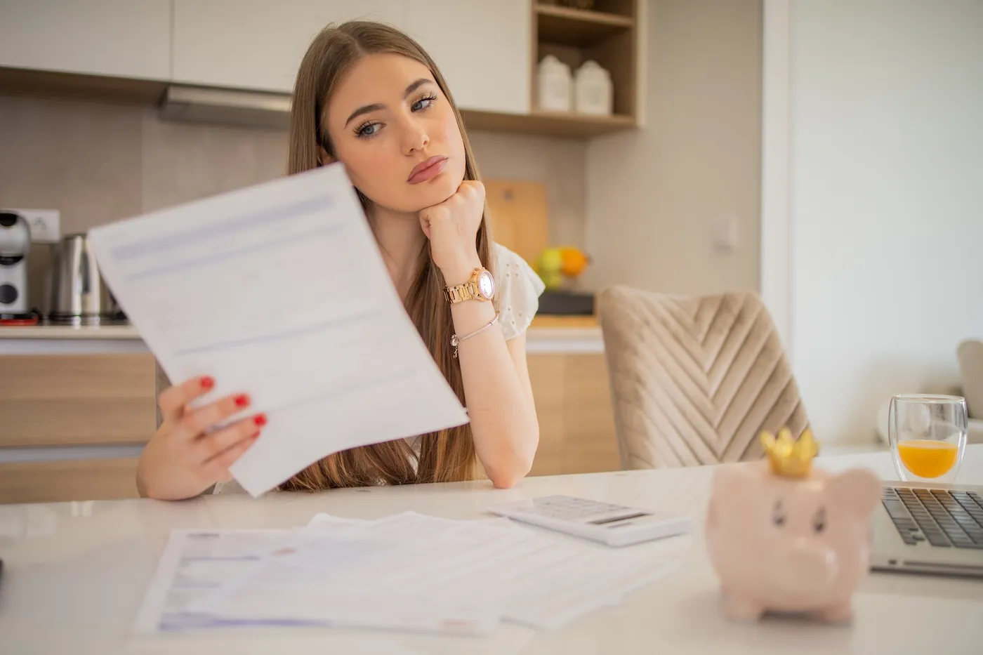 Woman reviewing car insurance papers at home.