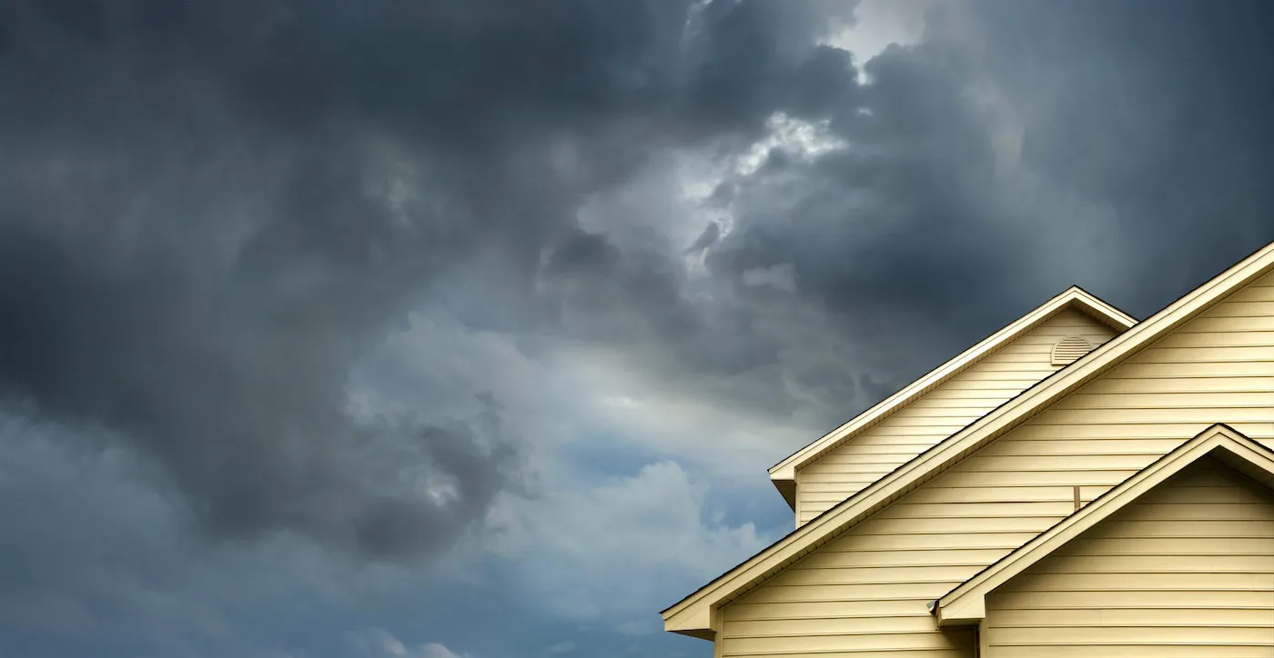 House against dark gloomy cloudy sky.