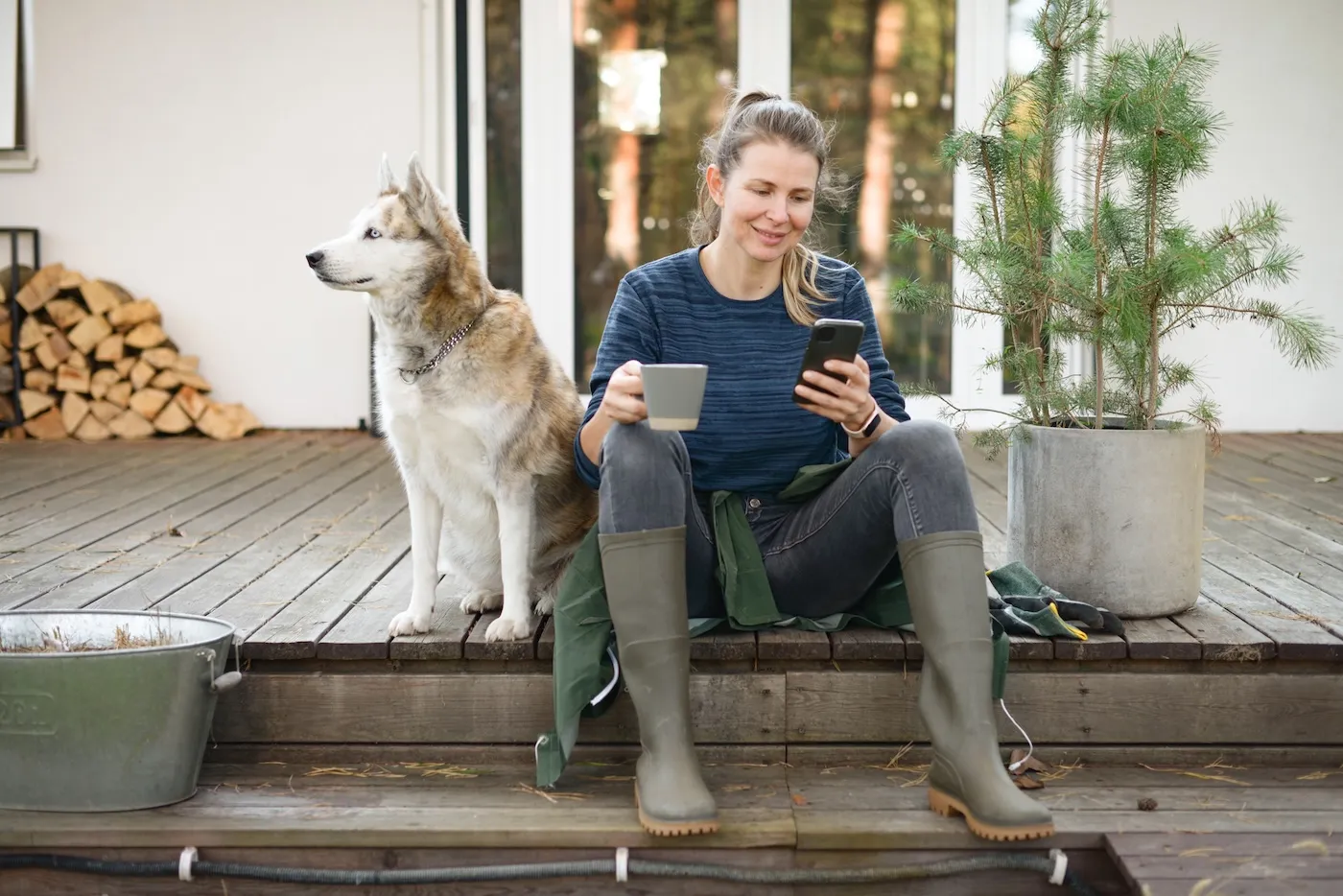 A woman working in the garden with her dog